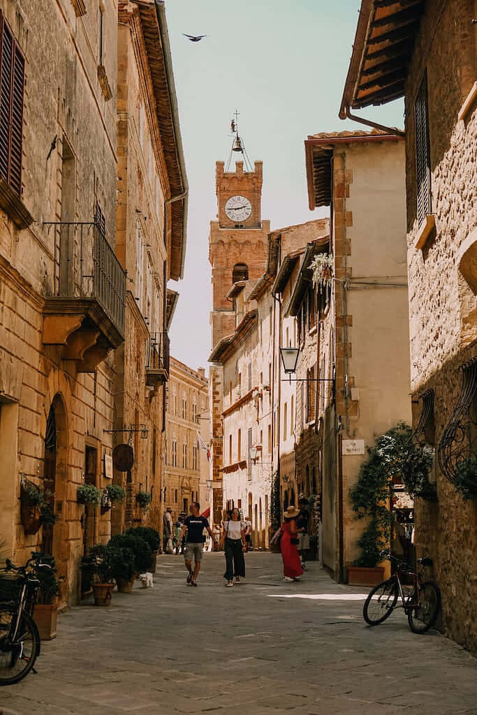 Charming Pienza Main Street: Stone Buildings & Historic Clock Tower Wallpaper