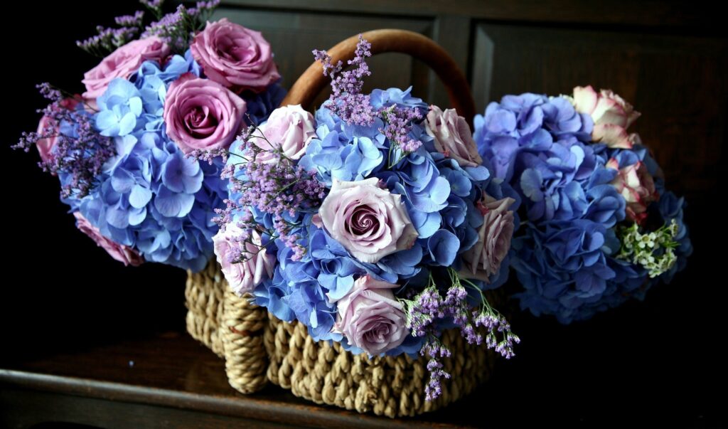 Charming Pink Roses & Blue Hydrangeas Wallpaper in Rustic Basket
