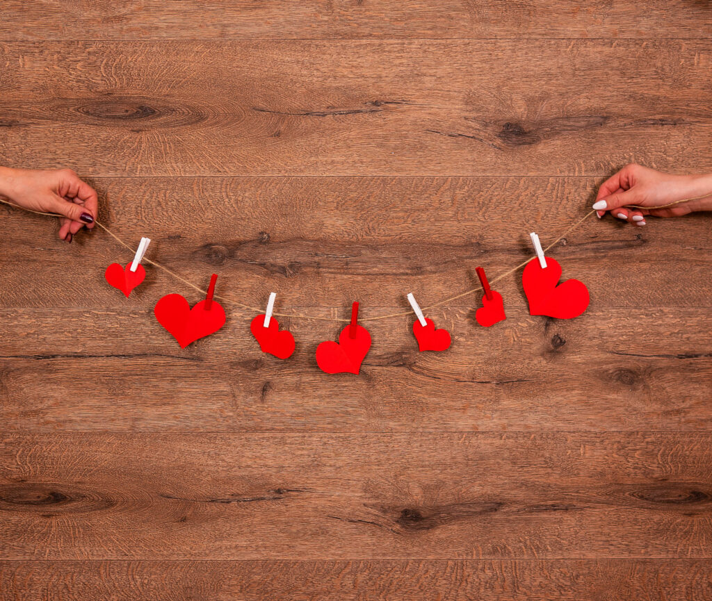 Charming Red Heart Cutouts on String - Aesthetic Wallpaper Background