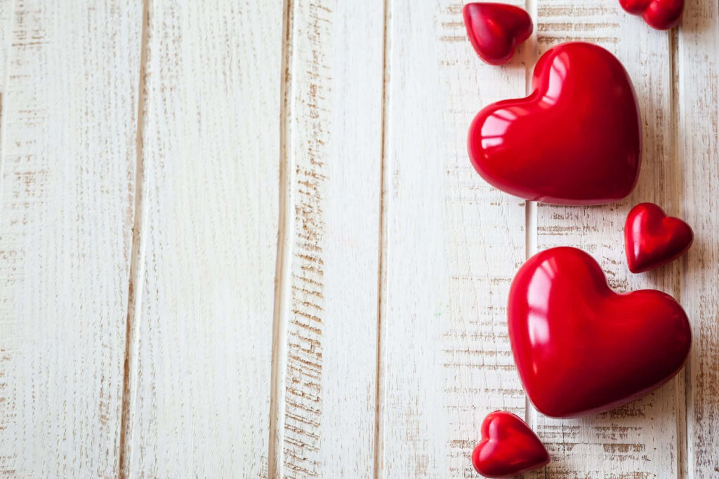 Rustic Wooden Background with Vibrant Red Heart Wallpaper
