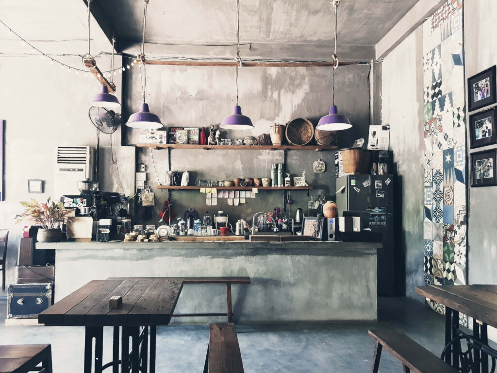 Charming Rustic Cafe Interior with Purple Pendant Lights & Warm Decor Wallpaper