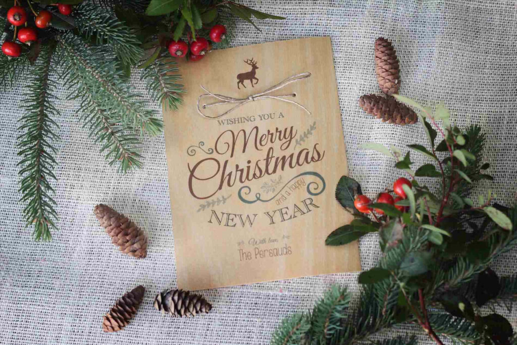 Cozy Rustic Christmas Card with Reindeer and Festive Decor Wallpaper