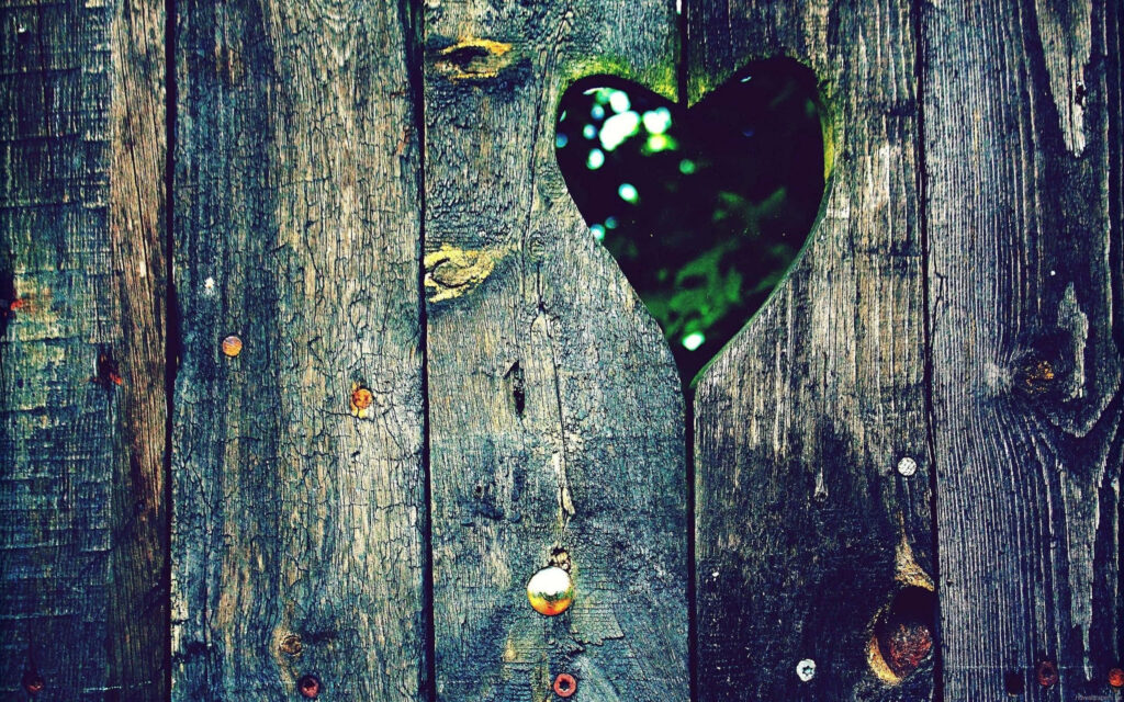 Charming Rustic Fence with Heart Hole & Lush Greenery Wallpaper