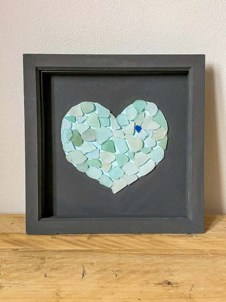 Charming Sea Glass Heart Art: Soft Pastels on Dark Wallpaper