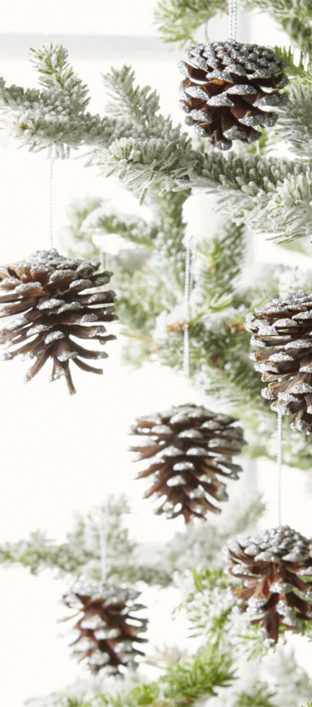 Charming Christmas Tree Wallpaper with Pine Cones & Snowy Decor