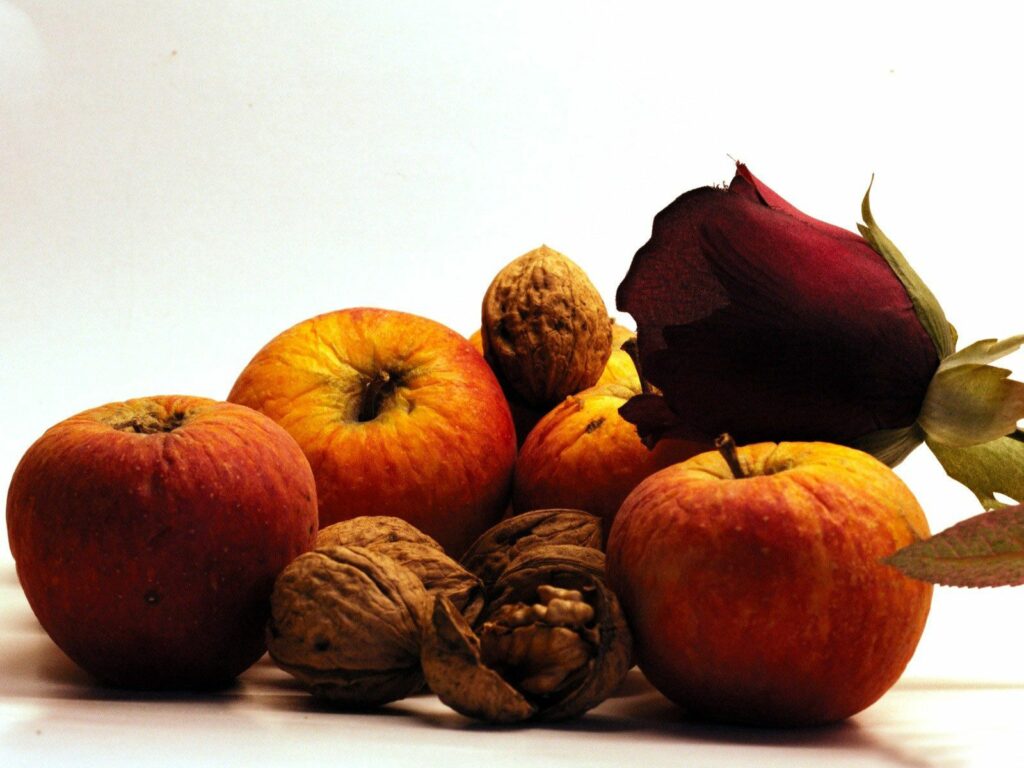 Elegant Still Life: Fresh Apples, Walnuts & Red Rose Wallpaper