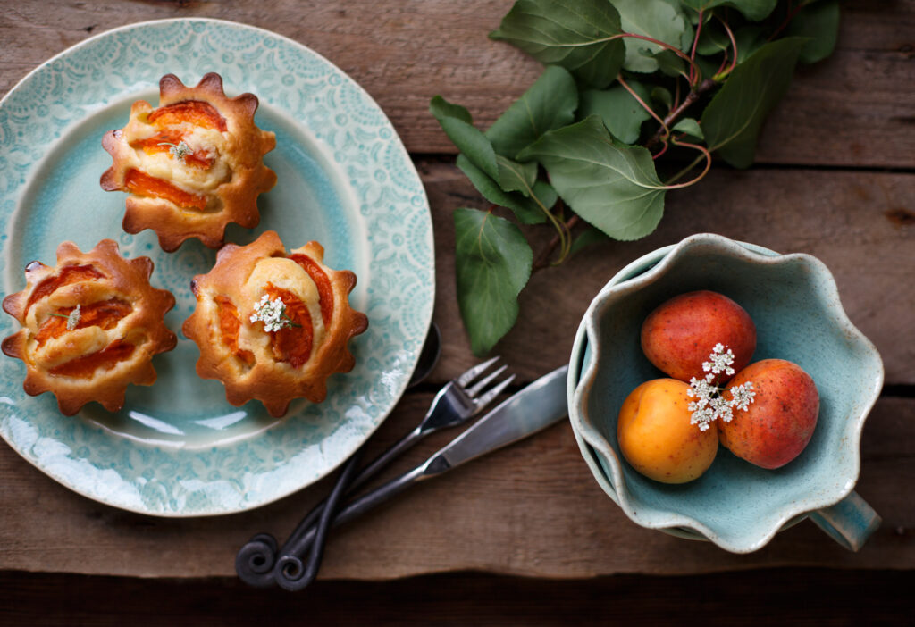 Charming Still Life Wallpaper: Fresh Pastries & Ripe Apricots