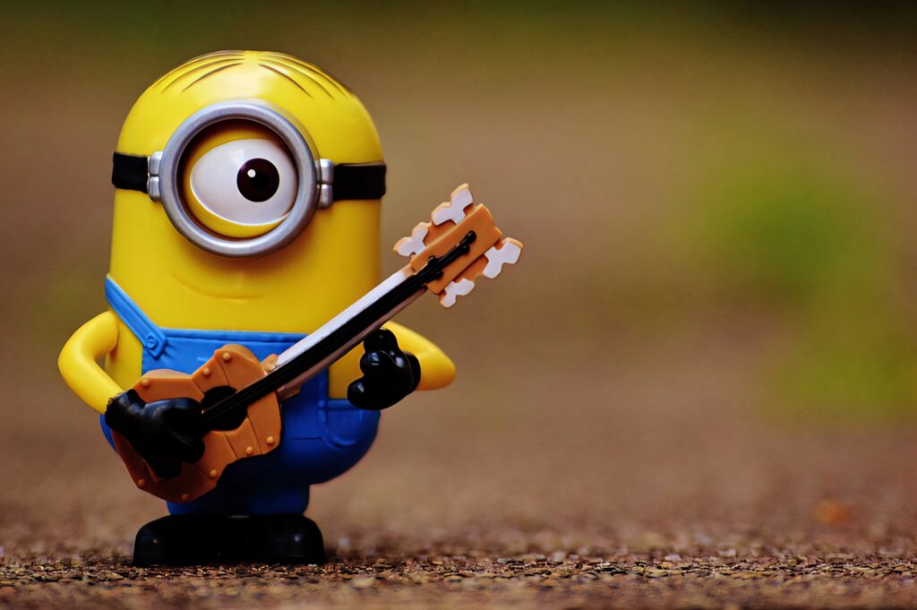 Charming Stuart the Minion Wallpaper: Musical Moment in Denim Overalls