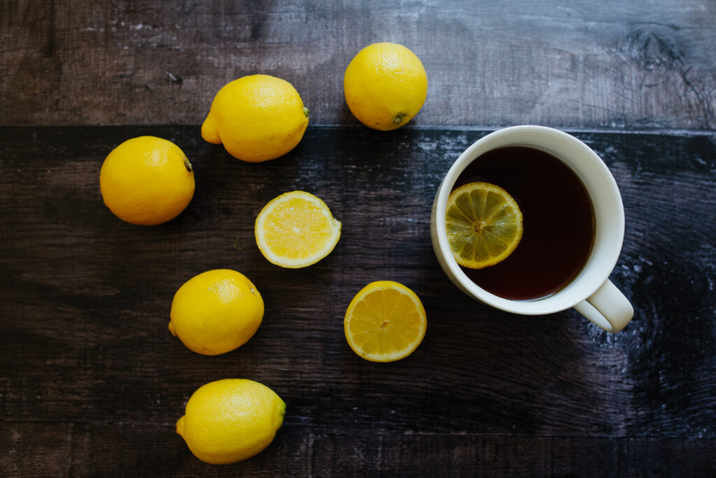 Elegant Tea and Lemon Wallpaper on Dark Wood Background