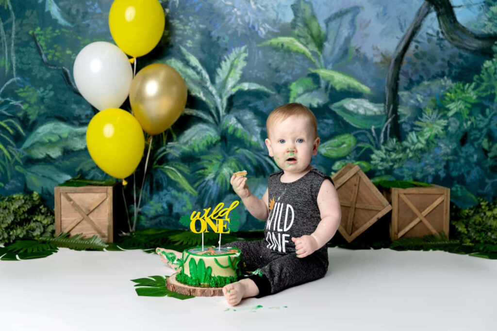 “Jungle-Themed Cake Smash: Delightful Toddler Surrounded by Fun!” Wallpaper