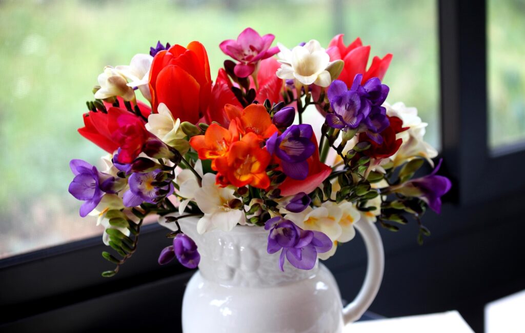Cheerful Tulip and Freesia Bouquet Wallpaper for a Lively Background