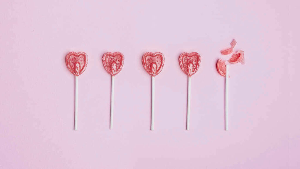 Valentine's Day Wallpaper: Heart-Shaped Lollipops on Pink Background
