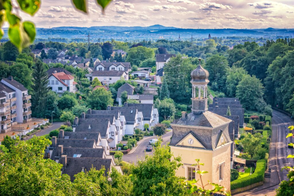 Charming Village Wallpaper: Idyllic Countryside with Lush Greenery
