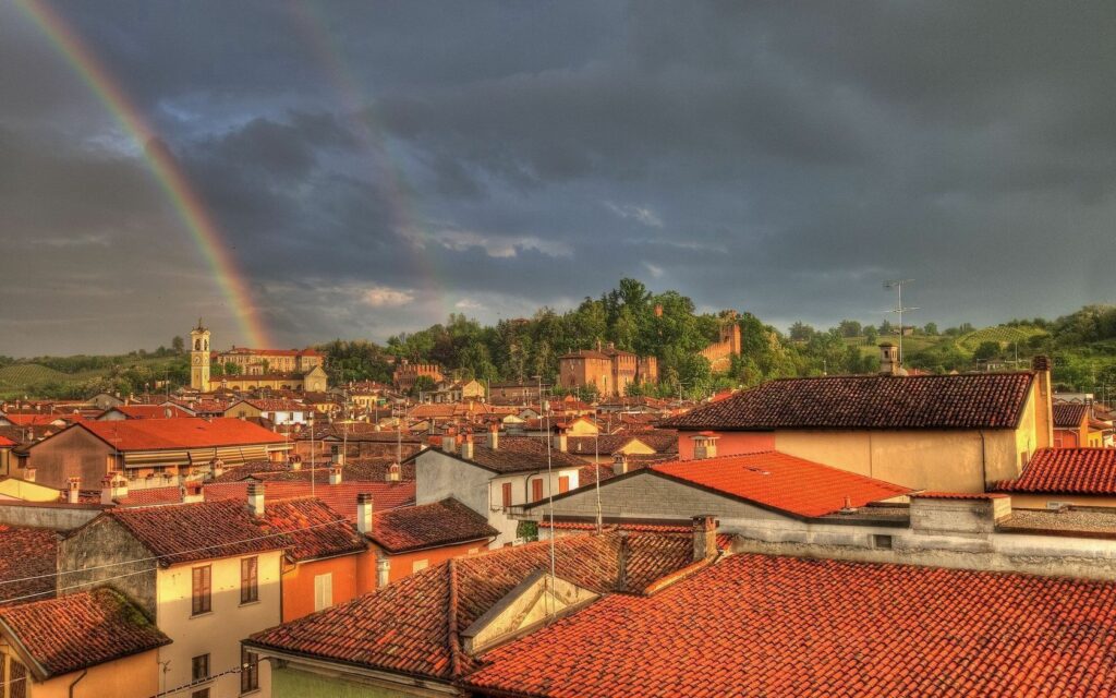 Charming Village Wallpaper: Double Rainbow Over Red-Tiled Rooftops
