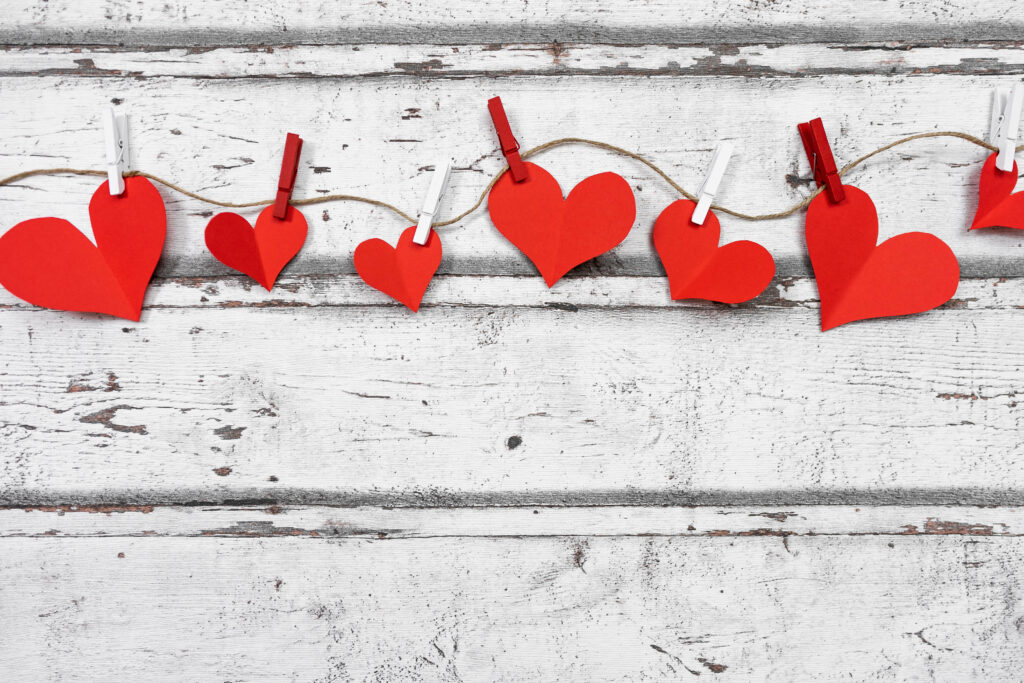 Cozy Red Heart Paper Cutout Wallpaper on Rustic White Wood