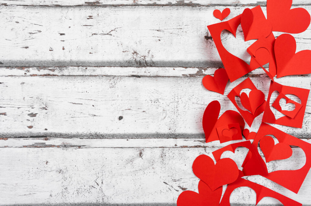 Charming Heart Paper Cutout Wallpaper on Rustic White Background