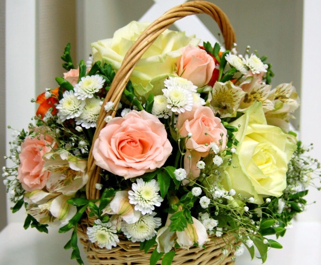 Charming Pastel Wallpaper: Wicker Basket with Elegant Floral Arrangement