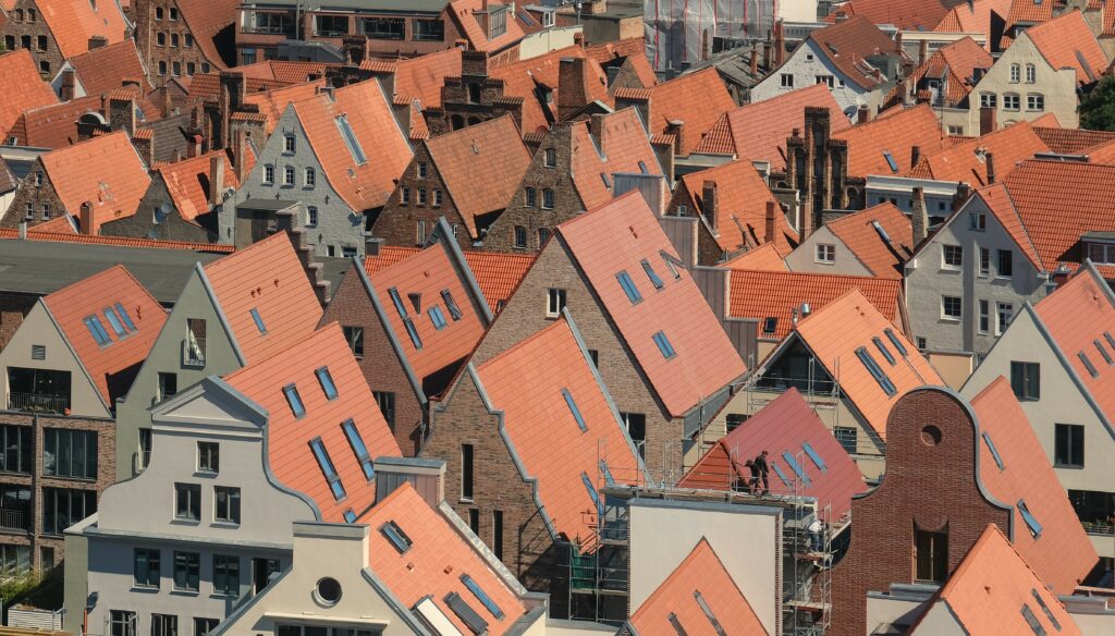 Charming Urban Wallpaper: Packed Houses with Red Rooftops