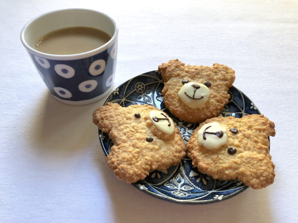 Charming Bear-Shaped Cookies Wallpaper with Tea Cup Background