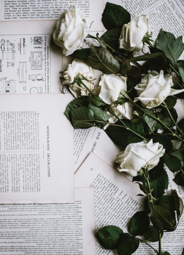 Vintage White Roses Wallpaper on Book Pages - Classic Background