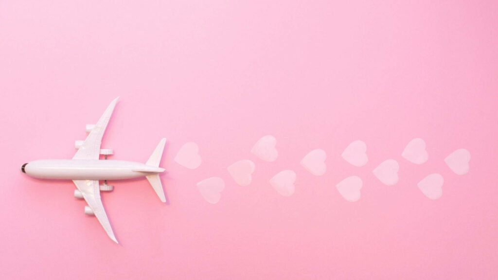 Whimsical Pink Wallpaper: White Toy Airplane & Heart Trail Design