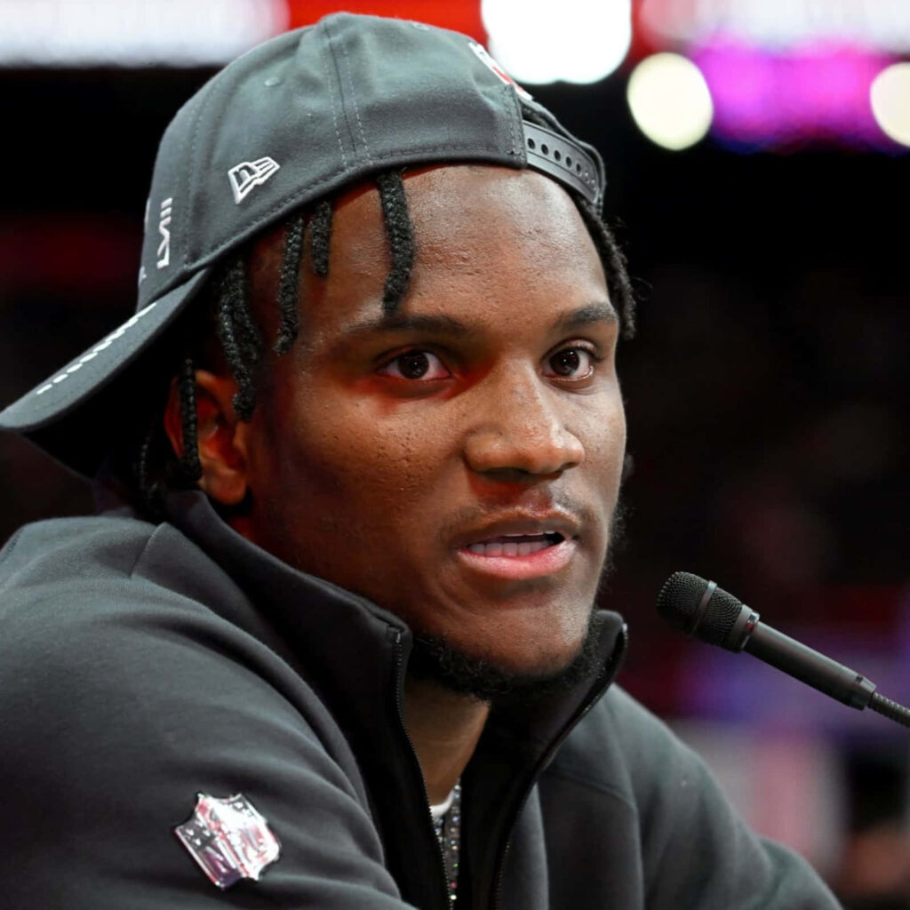 Charvarius Ward speaking at press conference wearing team jacket and cap focused face Wallpaper