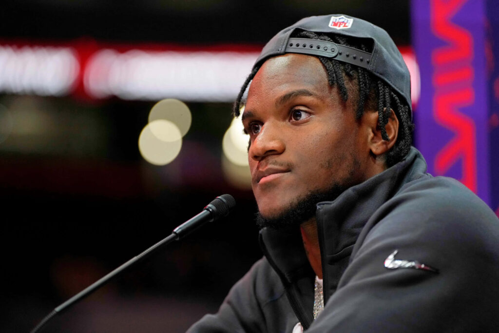 Charvarius Ward at NFL press conference wearing black Nike jacket and cap speaking to media Wallpaper