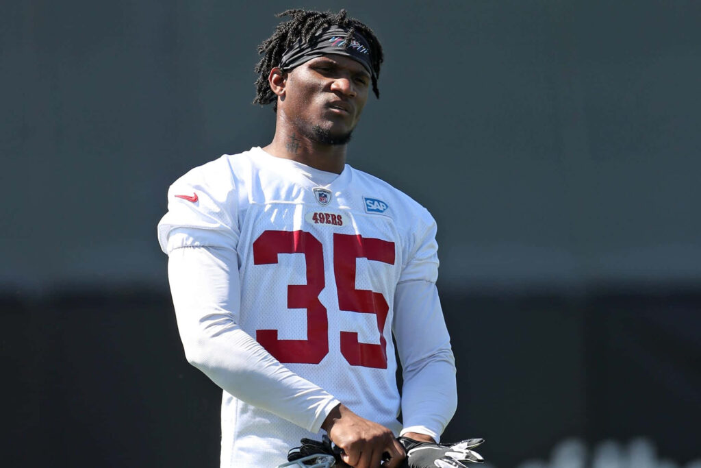 Charvarius Ward in number 35 49ers jersey during outdoor football training session focused Wallpaper