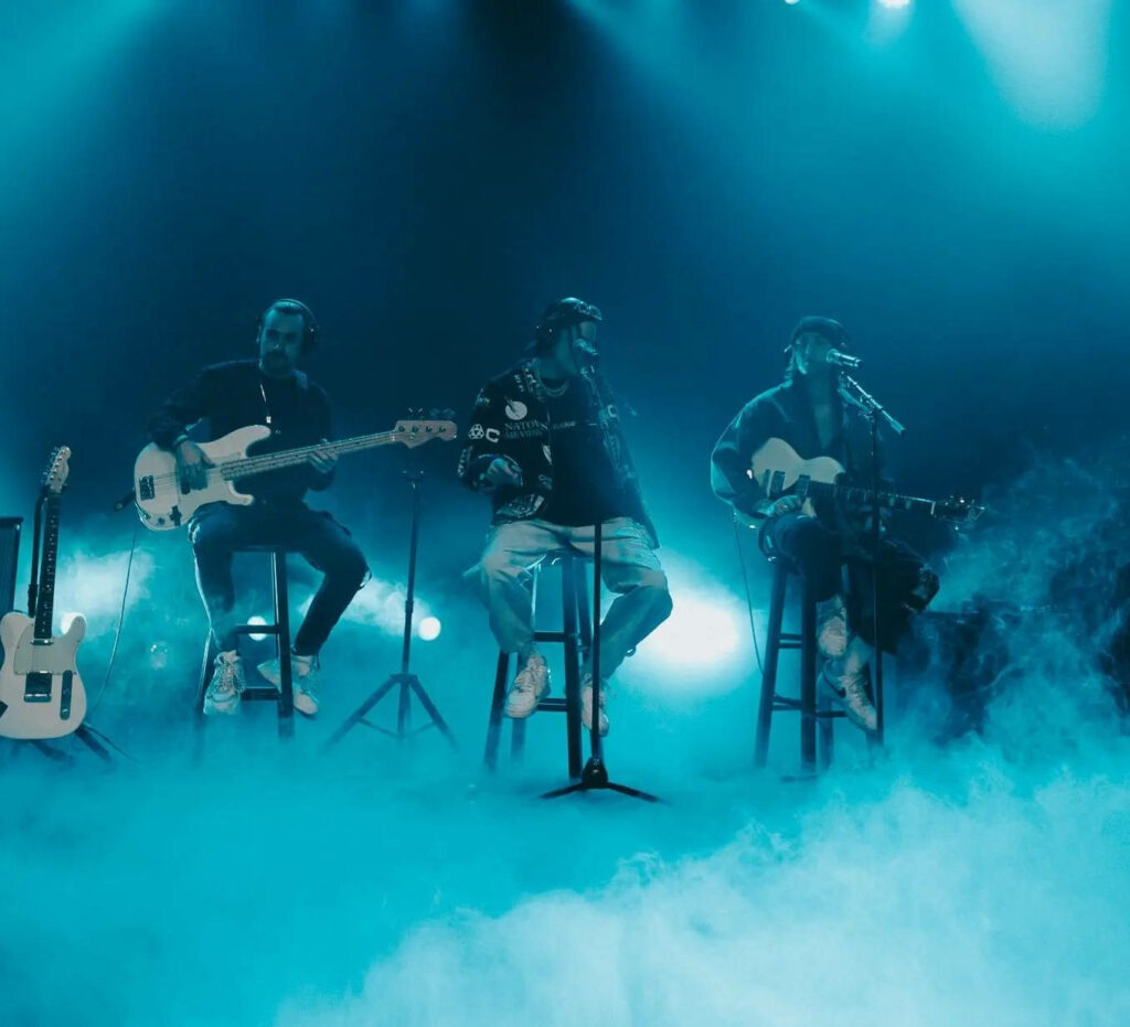 Chase Atlantic band performing with guitars on stage smoky blue lighting atmospheric concert wallpaper