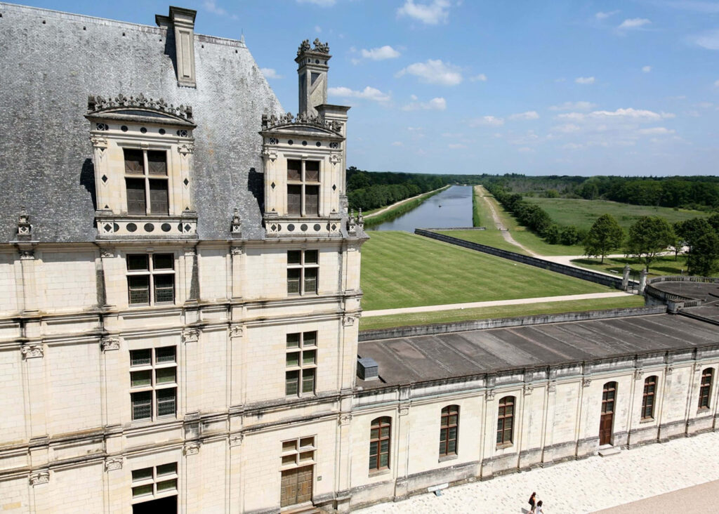 Dutch angle view of Château de Chambord with Renaissance architecture and landscaped grounds wallpaper