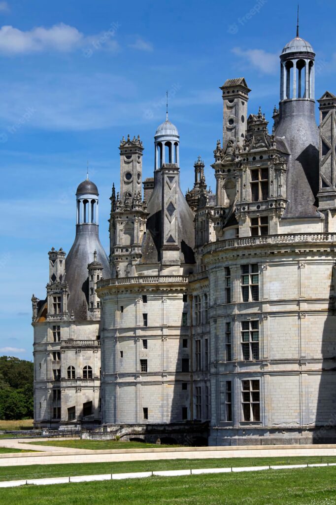Château de Chambord Renaissance architecture with towers viewed in dynamic Dutch angle under blue sky wallpaper