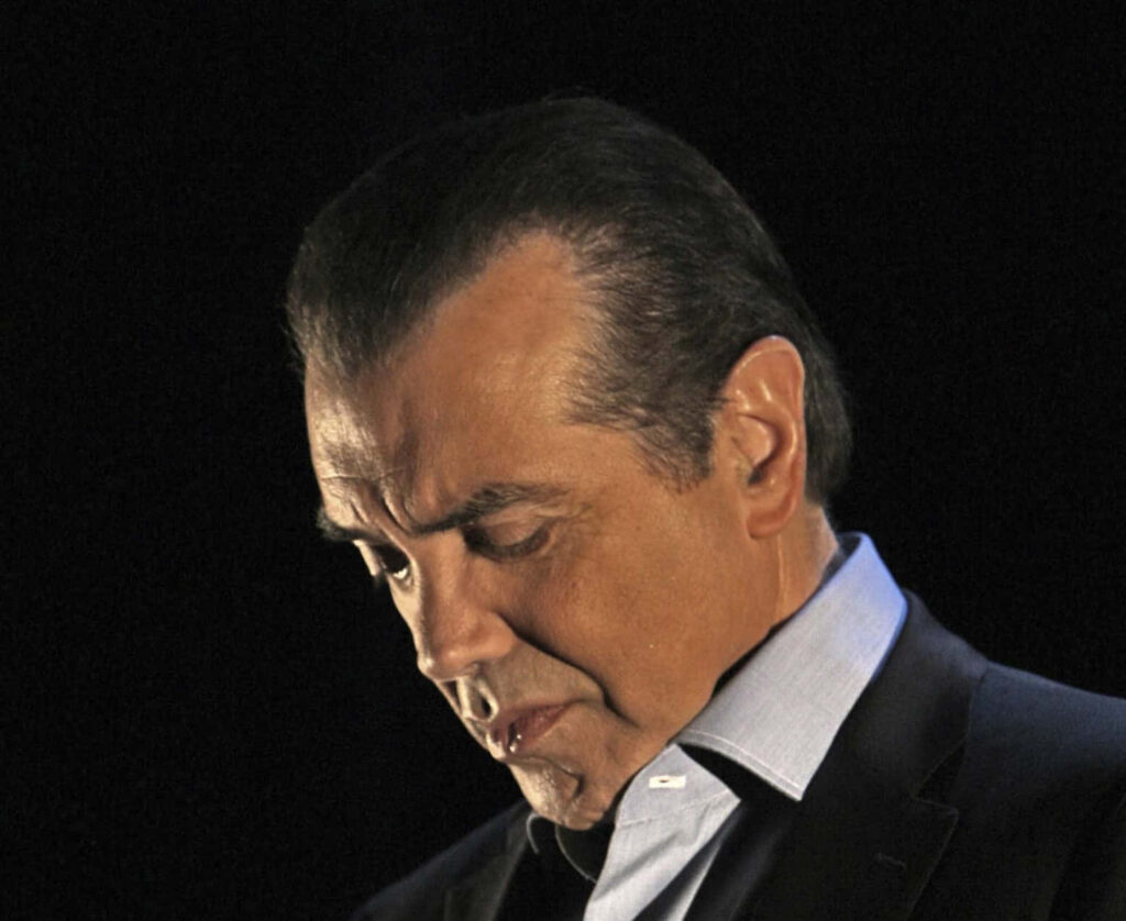 Chazz Palminteri contemplative portrait dark background cinematic lighting wallpaper image