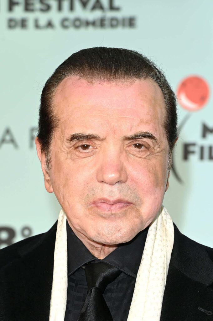 High-resolution portrait of Chazz Palminteri in formal suit with scarf on soft background Wallpaper
