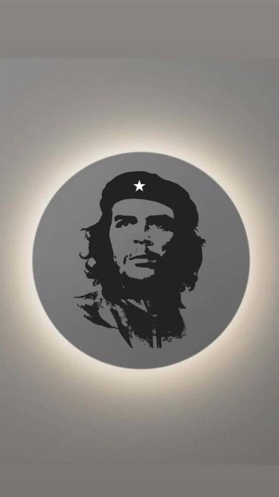 Che Guevara portrait wallpaper with beret star on gray circular background and halo effect