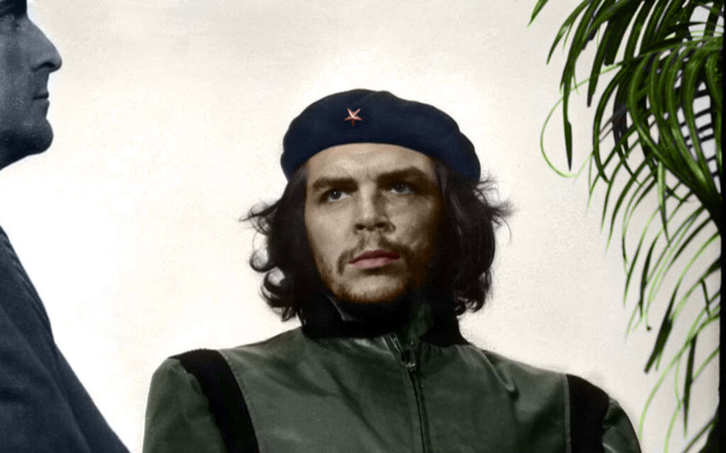 Che Guevara portrait wallpaper with determined expression and iconic black beret background
