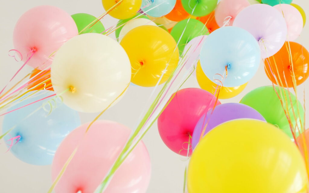 Birthday Bliss: Vibrant Balloons Dance Under a Blue Sky in this Colorful Holiday Wallpaper