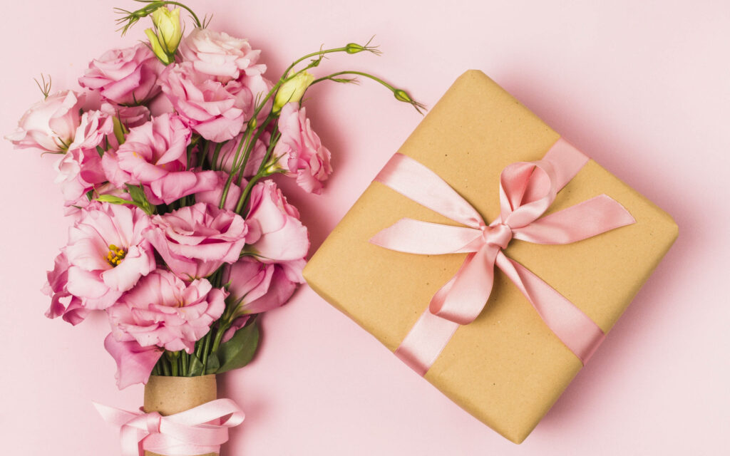 Cheerful Birthday Wallpaper: Wrapped Gift & Pink Flowers Design