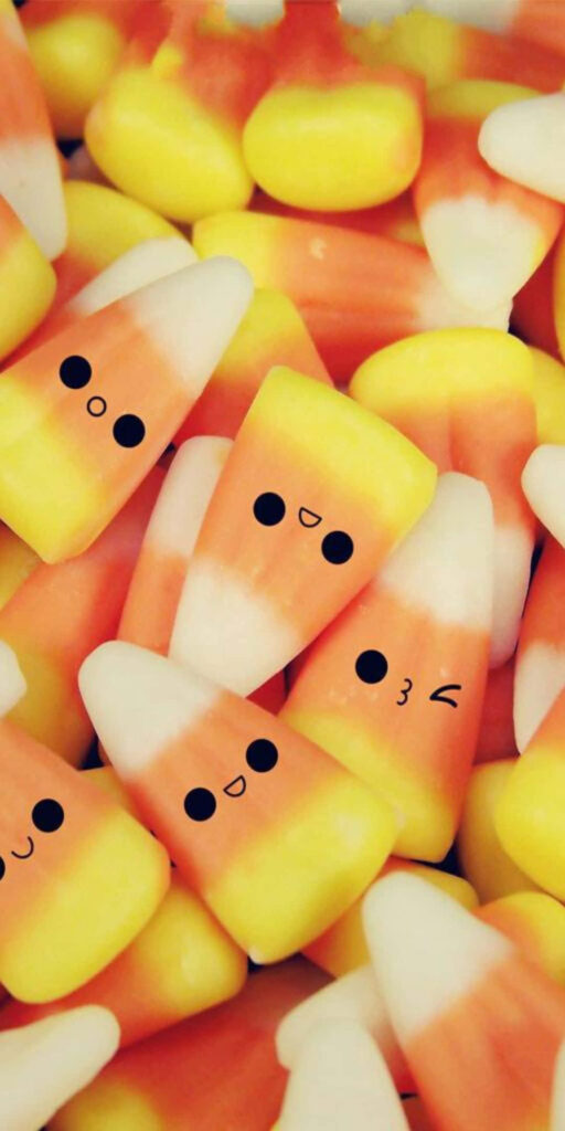 Cheerful Candy Corn Wallpaper: Playful & Colorful Festive Background