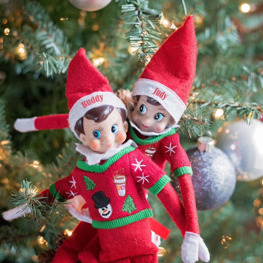 Cheerful Christmas Elves with Sparkling Tree Wallpaper Background