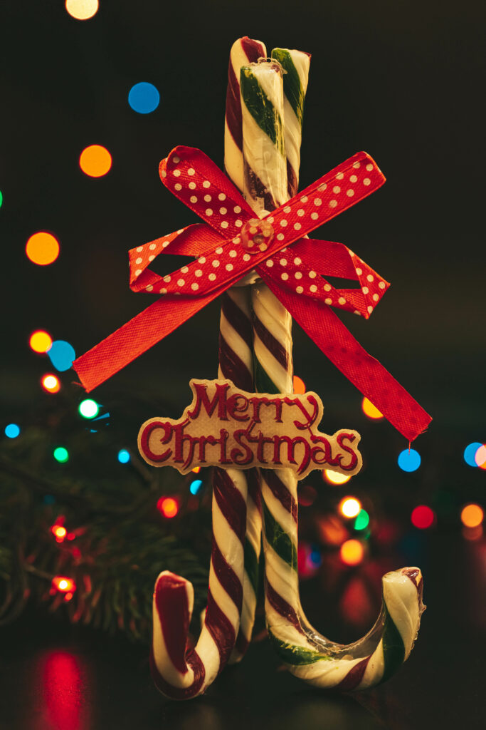 Cheerful Christmas Background: Candy Canes & Colorful Lights Wallpaper