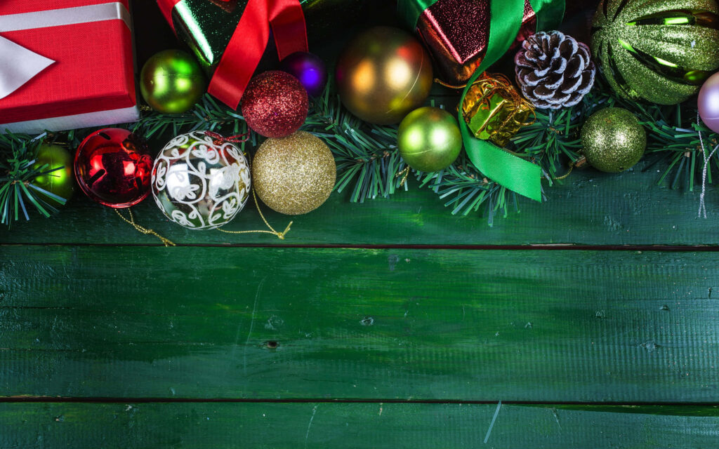 Festive Green Wooden Background with Colorful Christmas Decor Wallpaper