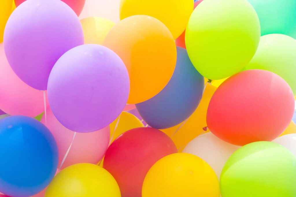 Colorful balloons floating joyfully in bright sky festive wallpaper background celebration