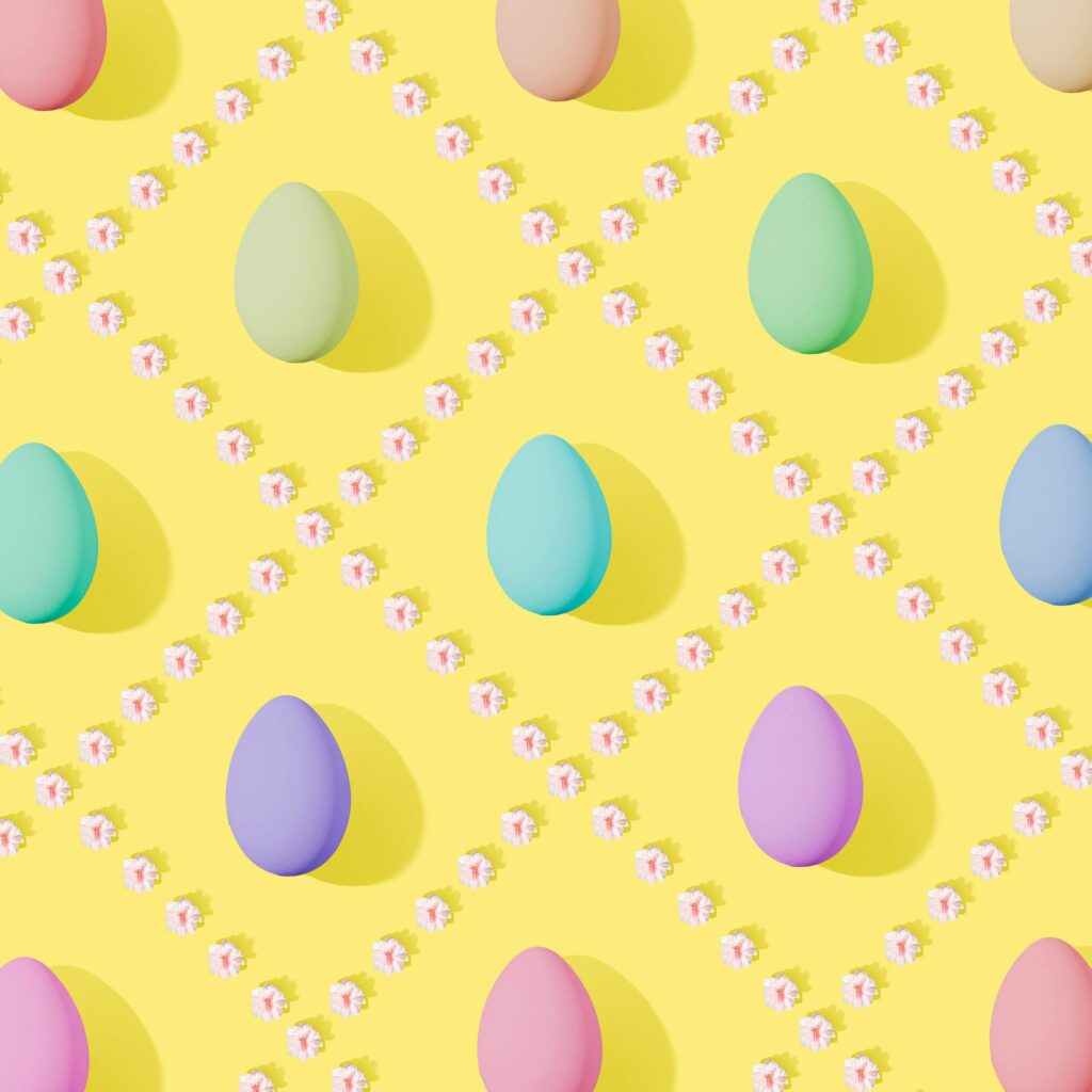 Cheerful Easter Wallpaper with Pastel Eggs & Flowers on Yellow