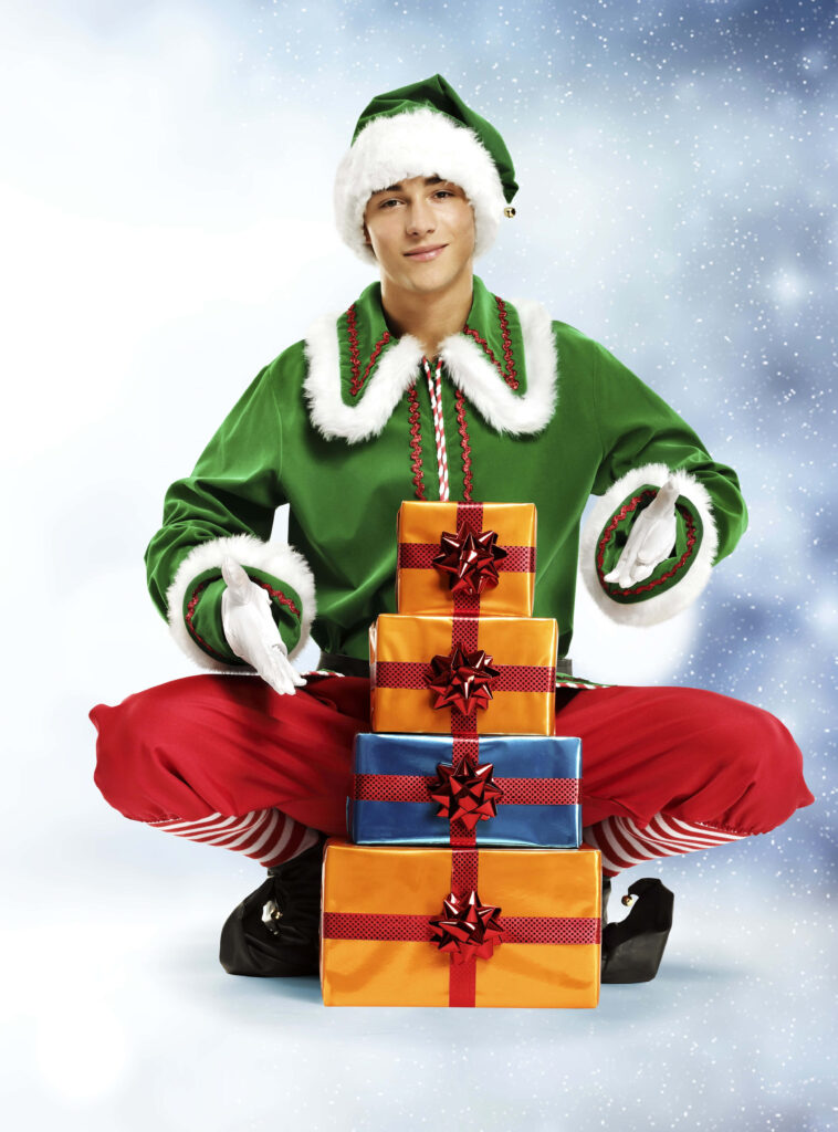 Cheerful Elf Wallpaper: Festive Green Outfit & Snowy Christmas Scene
