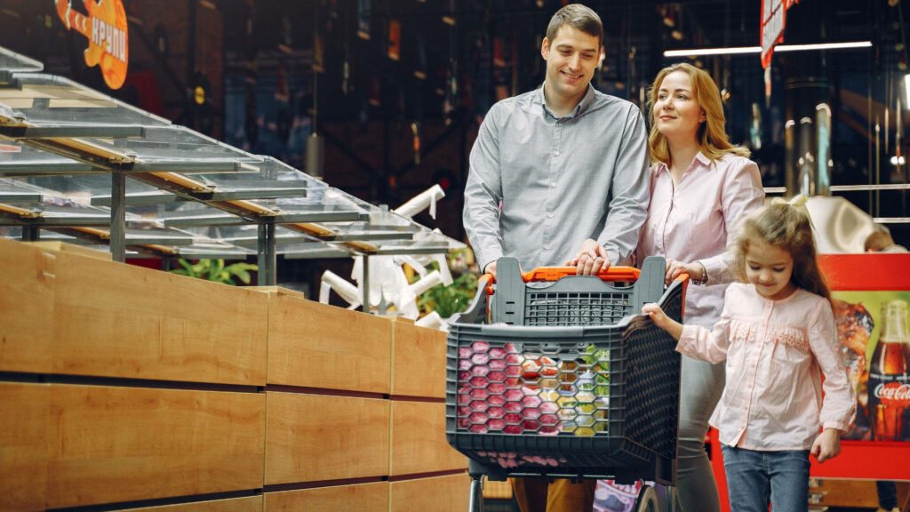 Cheerful Family Shopping Together in Grocery Store Wallpaper
