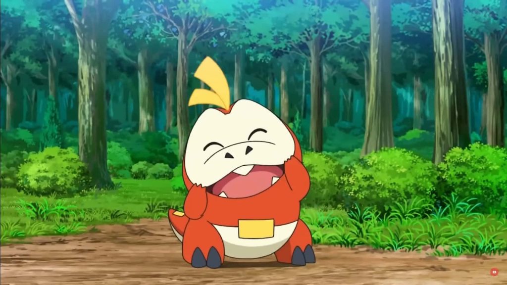 Cheerful Fuecoco laughing in vibrant forest anime wallpaper for Pokémon fans background