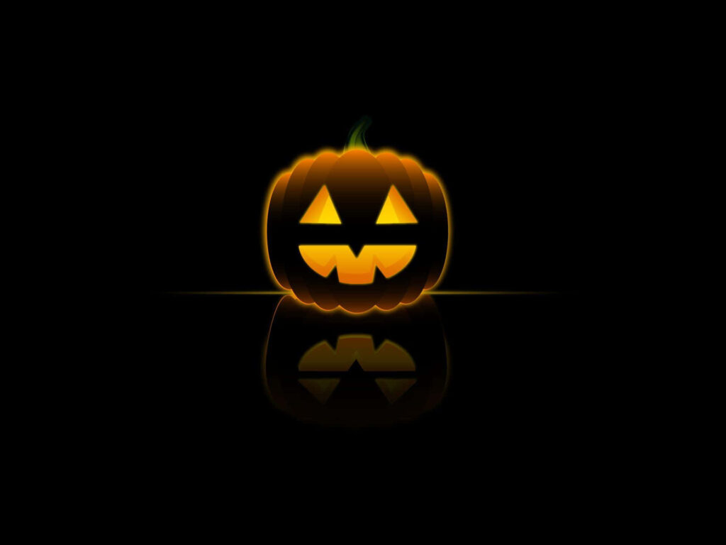 Cheerful Jack-o'-Lantern Illuminating Dark Background with Warm Light Wallpaper
