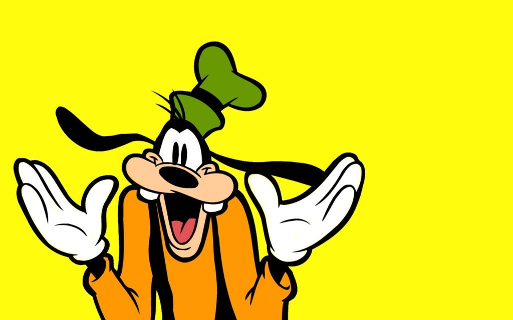 Goofy shrugging cheerful Disney character in orange sweater green hat on vibrant yellow background Wallpaper