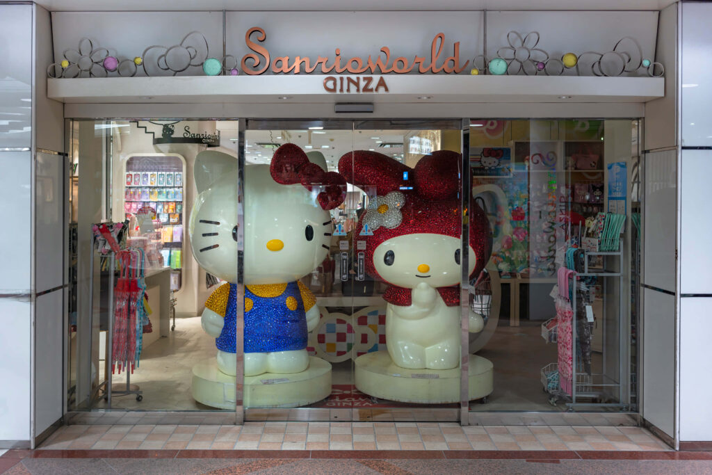Cheerful Sanrio Wallpaper: Colorful Hello Kitty Statues & Playful Vibe