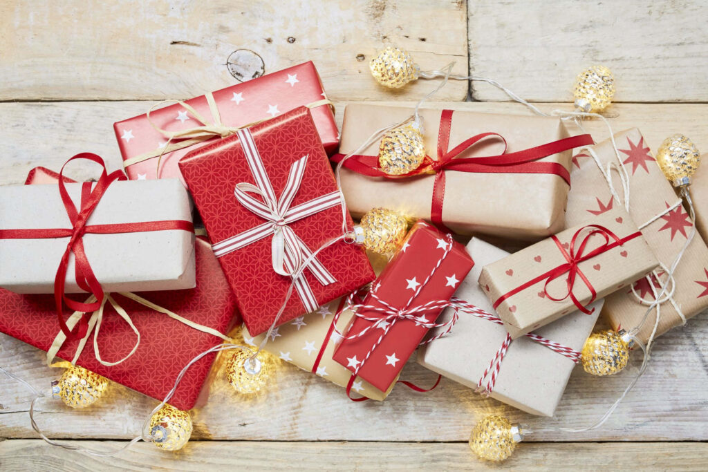 Cheerful Holiday Gift Boxes with Ribbons and Fairy Lights Wallpaper